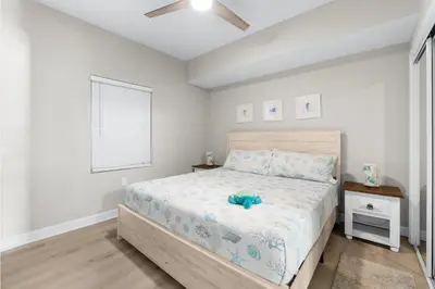 a bedroom with a bed with a blue stuffed animal on it at Seychelles 1302 by InJoy Vacations in Panama City Beach