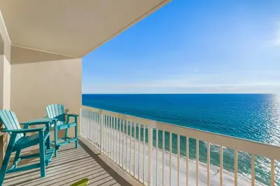 a balcony with two chairs and the ocean at Seychelles 1302 by InJoy Vacations in Panama City Beach