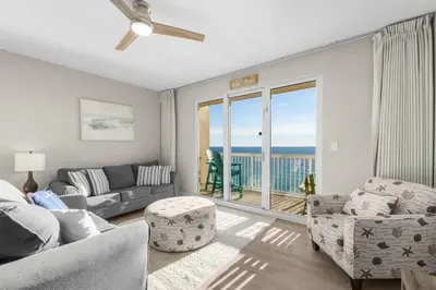 a living room with a view of the ocean at Seychelles 1302 by InJoy Vacations in Panama City Beach
