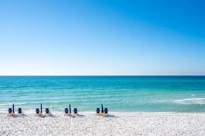 a group of umbrellas and chairs on the beach at Green Wave in Inlet Beach
