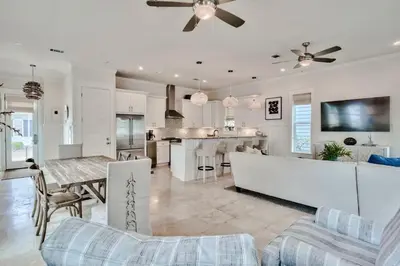 a kitchen and living room with a couch and a table at Green Wave in Inlet Beach