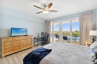 a bedroom with a bed and a flat screen tv at Remodeled 3BD plus Bunks! Low Floor Family Beach Resort! 5 Pools! by Dolce Vita Getaways PCB in Panama City Beach