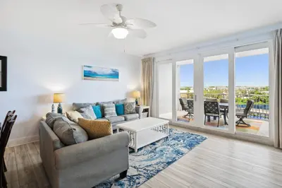 a living room with a couch and a table at Remodeled 3BD plus Bunks! Low Floor Family Beach Resort! 5 Pools! by Dolce Vita Getaways PCB in Panama City Beach