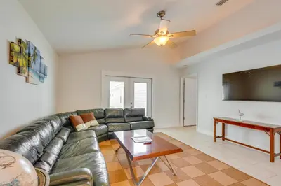 a living room with a leather couch and a table at 1 Mi to Beach Family-Friendly Home in PCB! in Panama City Beach