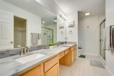 a bathroom with a sink and a large mirror at 1 Mi to Beach Family-Friendly Home in PCB! in Panama City Beach