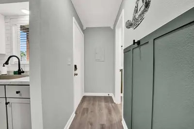 a hallway with a row of doors in a kitchen at Playa Tortuga-5 min walk to the beach in Panama City Beach