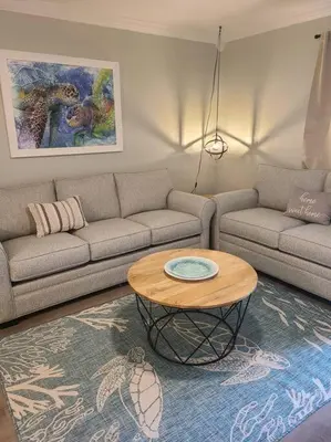 a living room with a couch and a table at Playa Tortuga-5 min walk to the beach in Panama City Beach