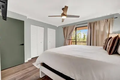 a bedroom with a bed and a ceiling fan at Playa Tortuga-5 min walk to the beach in Panama City Beach