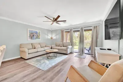 a living room with a couch and a ceiling fan at Playa Tortuga-5 min walk to the beach in Panama City Beach