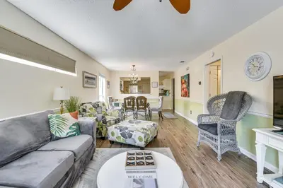 a living room with a couch and a table at Breezy PCB Vacation Rental with Lanai, Walk to Ocean in Panama City Beach