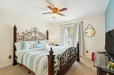a bedroom with a bed and a ceiling fan at Breezy PCB Vacation Rental with Lanai, Walk to Ocean in Panama City Beach