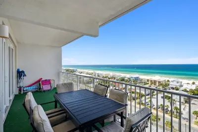 a balcony with a table and chairs and the beach at Laketown Wharf #1006 by Nautical Properties in Panama City Beach