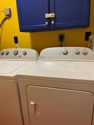 a kitchen with a washing machine and a blue cabinet at Vacation Home near Beach and Waterpark! in Panama City Beach