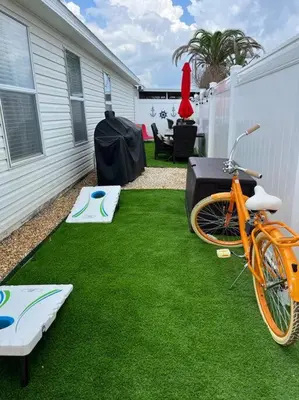 an orange bike parked on the grass in a backyard at Vacation Home near Beach and Waterpark! in Panama City Beach