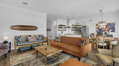 a living room with a couch and a table at Turtle Beach - 55 Nature Way #100 in Santa Rosa Beach