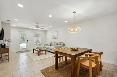 a living room with a table and a couch at Panama City Beach Vacation Rental about 1 Mi to Beach! in Panama City Beach