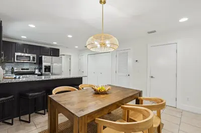 a kitchen with a wooden table and chairs at Panama City Beach Vacation Rental about 1 Mi to Beach! in Panama City Beach