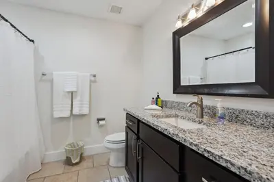 a bathroom with a sink and a toilet and a mirror at Panama City Beach Vacation Rental about 1 Mi to Beach! in Panama City Beach