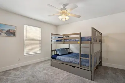 a bedroom with two bunk beds and a ceiling fan at Panama City Beach Vacation Rental about 1 Mi to Beach! in Panama City Beach