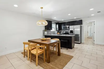 a kitchen with a wooden table and chairs and a dining room at Panama City Beach Vacation Rental about 1 Mi to Beach! in Panama City Beach