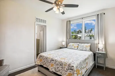 a bedroom with a bed and a ceiling fan at Cove Cottage - 3 Bedroom withPrivate Pool, Sleeps 6, Quiet Community, Close to Fishing Marinas, home in Panama City