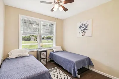 a bedroom with two beds and a window at Cove Cottage - 3 Bedroom withPrivate Pool, Sleeps 6, Quiet Community, Close to Fishing Marinas, home in Panama City