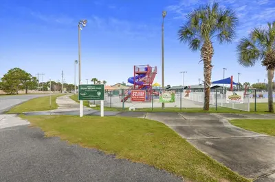 a park with a playground with a slide and palm trees at Cove Cottage - 3 Bedroom withPrivate Pool, Sleeps 6, Quiet Community, Close to Fishing Marinas, home in Panama City