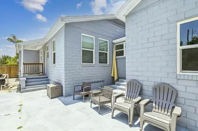 a patio with two chairs and a table at Cove Cottage - 3 Bedroom withPrivate Pool, Sleeps 6, Quiet Community, Close to Fishing Marinas, home in Panama City