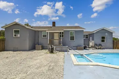 a house with a swimming pool in front of it at Cove Cottage - 3 Bedroom withPrivate Pool, Sleeps 6, Quiet Community, Close to Fishing Marinas, home in Panama City