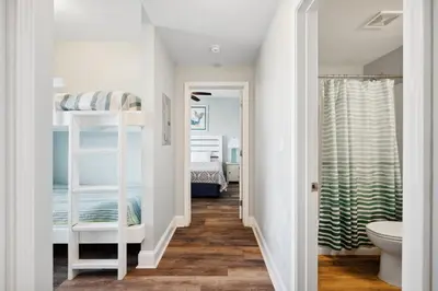 a hallway leading to a bedroom with bunk beds at Laketown Wharf #1707 by Nautical Properties in Panama City Beach