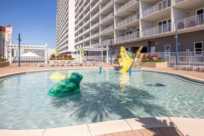 a pool with a green turtle in the water at Laketown Wharf #1707 by Nautical Properties in Panama City Beach