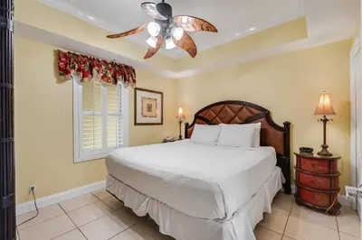 a bedroom with a bed and a ceiling fan at Calypso Resort Serenity 1 in Panama City Beach