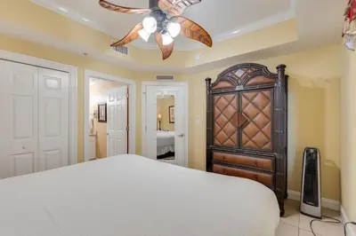 a bedroom with a bed and a ceiling fan at Calypso Resort Serenity 1 in Panama City Beach