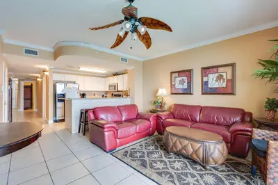 a living room with red leather furniture and a ceiling fan at Calypso Resort Serenity 1 in Panama City Beach