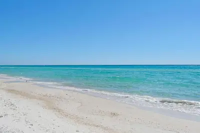 a sandy beach with the ocean in the background at Sunbird 604W in Panama City Beach