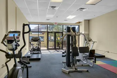a gym with treadmills and cardio machines in a room at Sunbird 604W in Panama City Beach