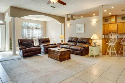 a living room with leather couches and a table at Pet-Friendly Panama City Beach Home Near Beaches! in Panama City Beach