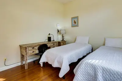 a bedroom with two beds and a desk with a desk at Pet-Friendly Panama City Beach Home Near Beaches! in Panama City Beach
