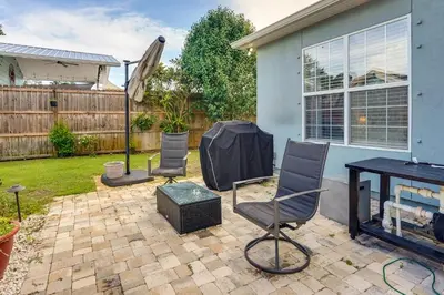 a patio with chairs and a table in a yard at Pet-Friendly Panama City Beach Home Near Beaches! in Panama City Beach