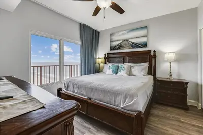 a bedroom with a bed and a balcony at Shores of Panama 2326 - 1 Bedroom Bunks Sleeps 6, Reserved Parking! condo in Panama City Beach