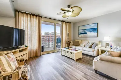 a living room with a couch and a tv at Shores of Panama 2326 - 1 Bedroom Bunks Sleeps 6, Reserved Parking! condo in Panama City Beach