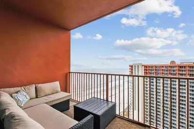 a living room with a couch and a balcony at Shores of Panama 2326 - 1 Bedroom Bunks Sleeps 6, Reserved Parking! condo in Panama City Beach