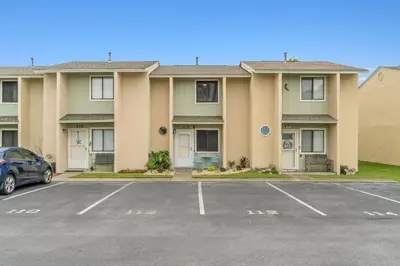 a parking lot in front of a building at Beach, pools, tennis, Gulf Highlands Beach Resort in Panama City Beach