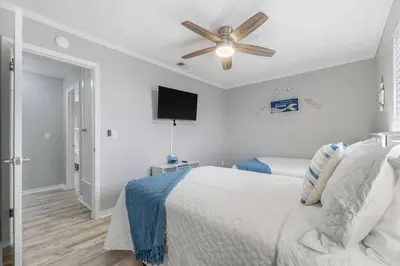 a bedroom with a bed and a ceiling fan at Beach, pools, tennis, Gulf Highlands Beach Resort in Panama City Beach