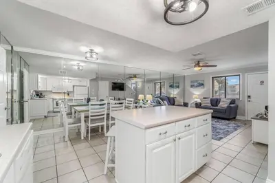 a kitchen and living room with a table and chairs at Beach, pools, tennis, Gulf Highlands Beach Resort in Panama City Beach