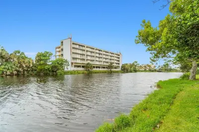 a building sitting on the side of a river at Beach, pools, tennis, Gulf Highlands Beach Resort in Panama City Beach