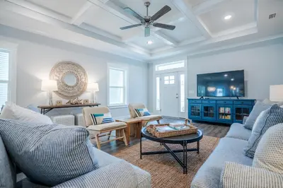a living room with two couches and a tv at Sand's Hideaway in Panama City Beach