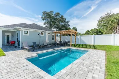 a backyard with a swimming pool and a fence at Sand's Hideaway in Panama City Beach