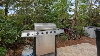 a barbecue grill with a sink and some bikes at Seagrove Serenity in Santa Rosa Beach