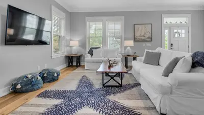 a living room with a white couch and a star rug at Seagrove Serenity in Santa Rosa Beach